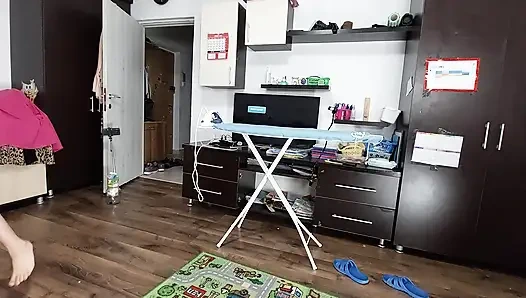 Sexy brunette doing naked chores around the house.