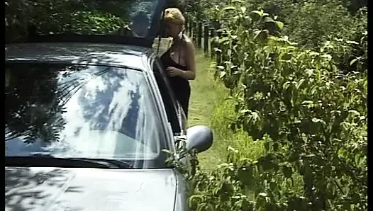Blonde German cougar with big tits rides dick in the trunk of a car