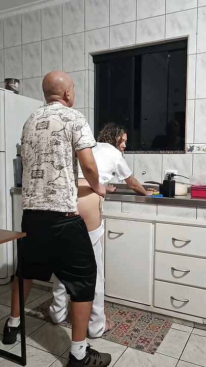 Banging the maid from behind in the kitchen.