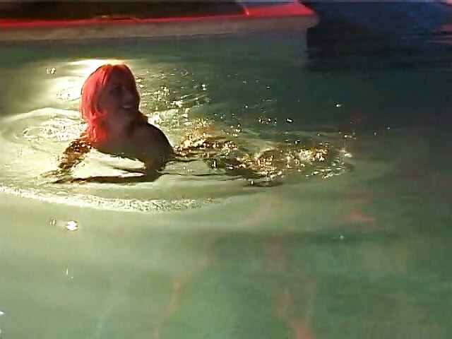 Two sexy lesbian chicks are swimming together in the swimming pool