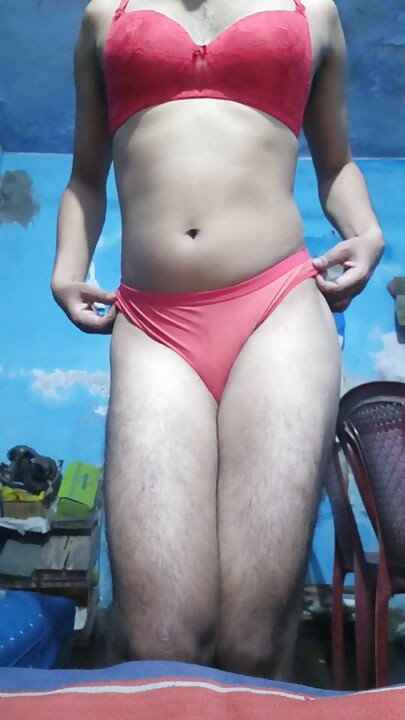 Young sissy crossdresser in her step sister's red bra and thong panties