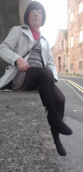 Stunning moment from "Crossdressing slut exposes her caged cock on public street"
