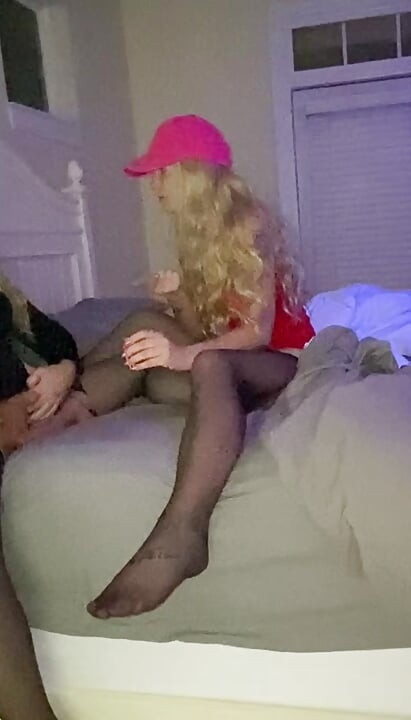 Hotwife and crossdressing hubby in bed in lingerie, stockings and  the wife is telling  Crossdresser a story about fucking