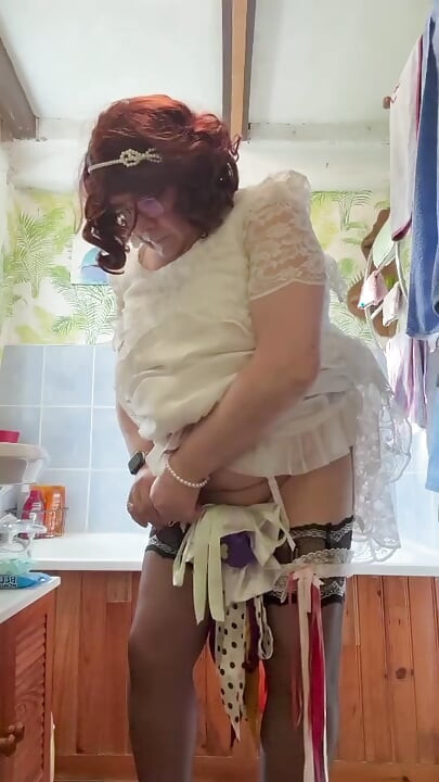 Dressed in a white lace dress to pee in a bottle