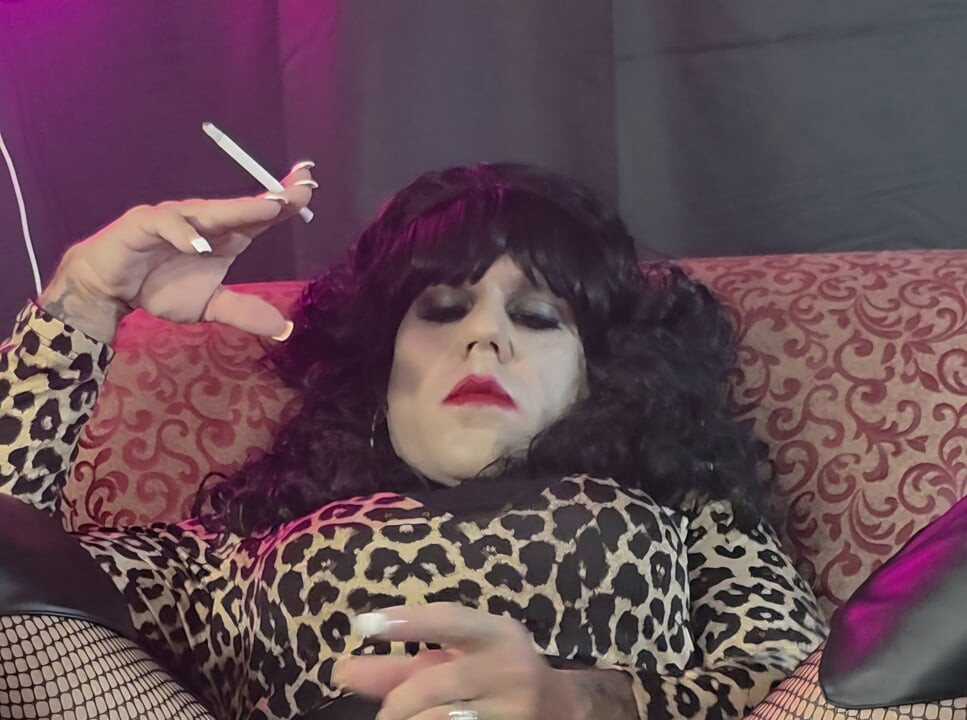 Crossdresser Cassandra smokes and strokes cock