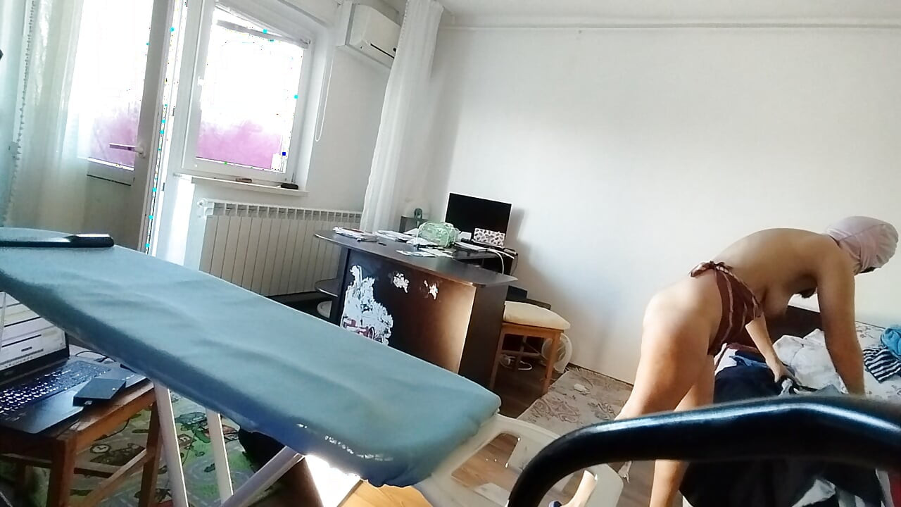 Amateur woman doing housework naked Sexy and naughty wife trying on clothes she cuts.