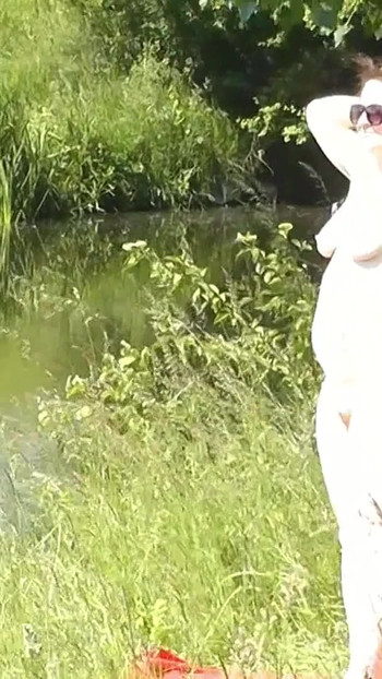 Thrilling moment from "Milf sexy woman sunbathing naked on river bank. Naked in public. Wild beach Nudist. Ass. Pussy."