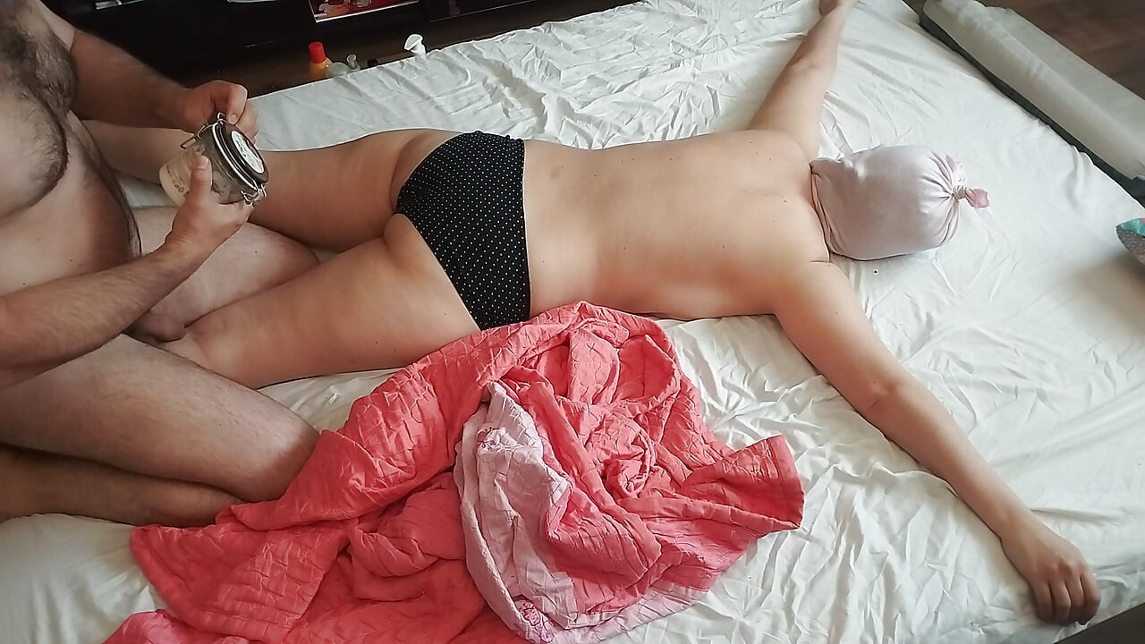 Sensual massage of a hot couple with oil on the body.