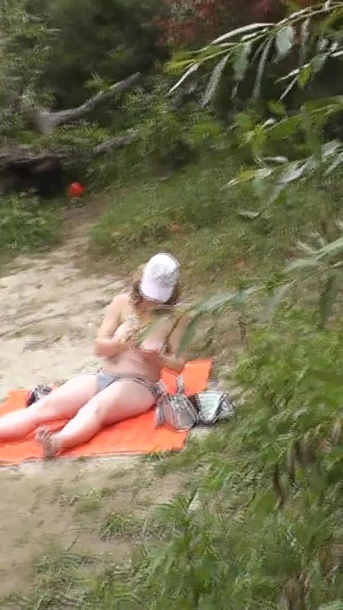 Wild beach. Random passerby guy peeps on sunbathing topless beautiful Milf on the river bank Outdoors. Outside. Naked in | Clip 1