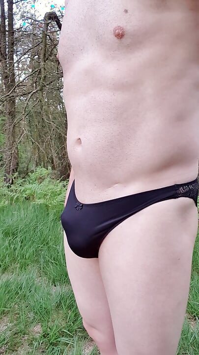 Smooth pantyboy walking around a forest and masturbating