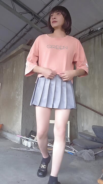 A Pleated Skirt Paired with White Underwear, and an Anal Plug Inserted on the Terrace