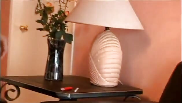 Smoking babe rams vibrator in pussy on couch