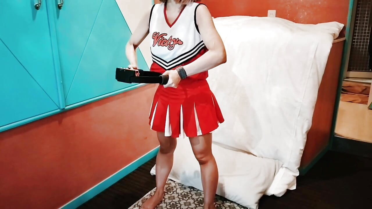 A cute, busty married woman does exercise 1 in an erotic cheerleader costume. Home made amateur Private Shoot