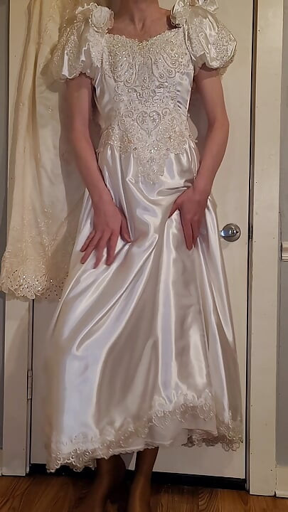 Trying on a liquid satin wedding dress.