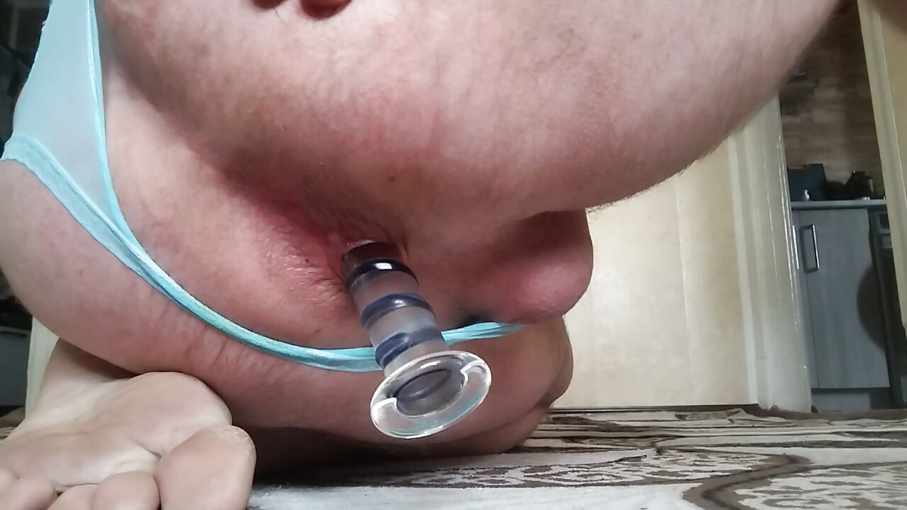 Chubby man tries on new sheer panties and fucks his ass with big glass dildo