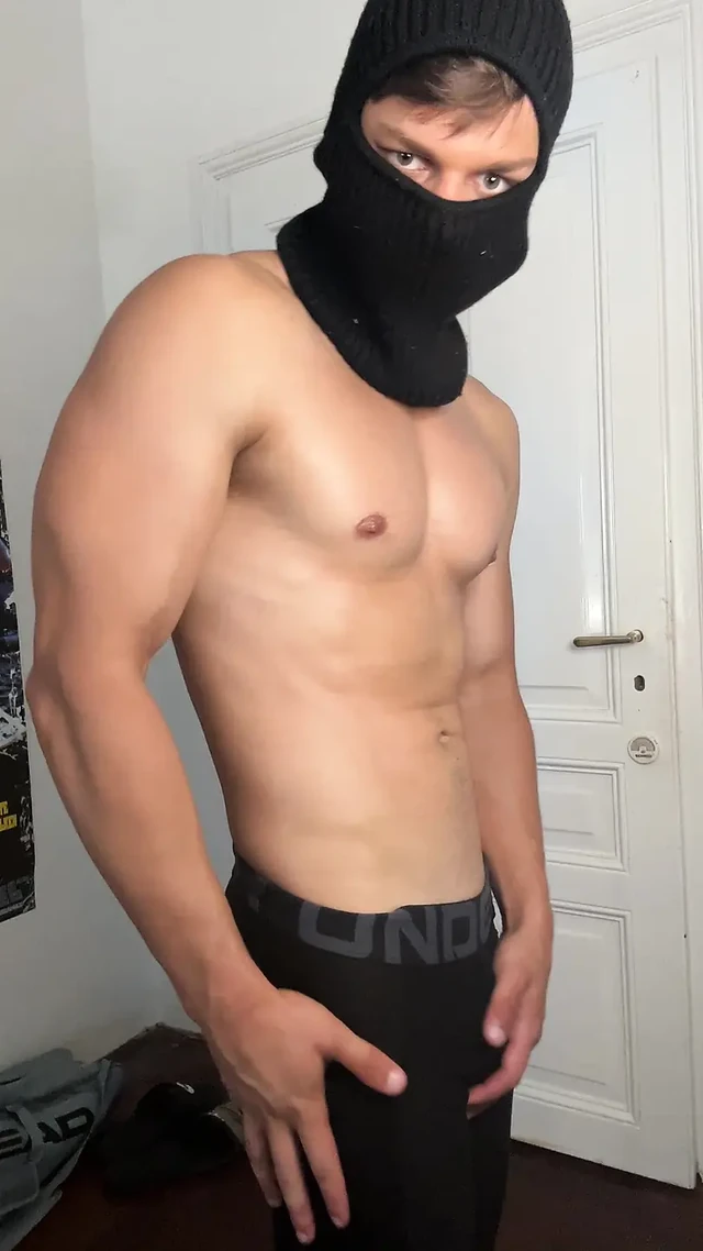 Masked hunk showing off his muscles