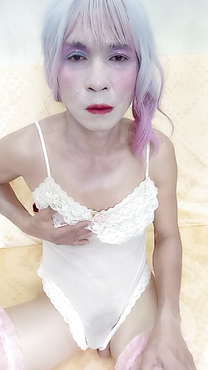 Oanh Le transgender wearing sexy porn clothes playing with a fake can