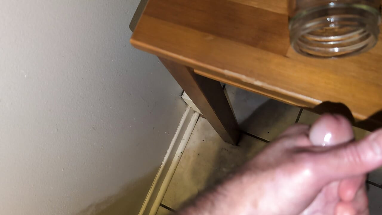 Fat man jerking his hard cock and cumming in a glass