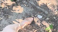 Walking in forest in shiny stocking and high heels