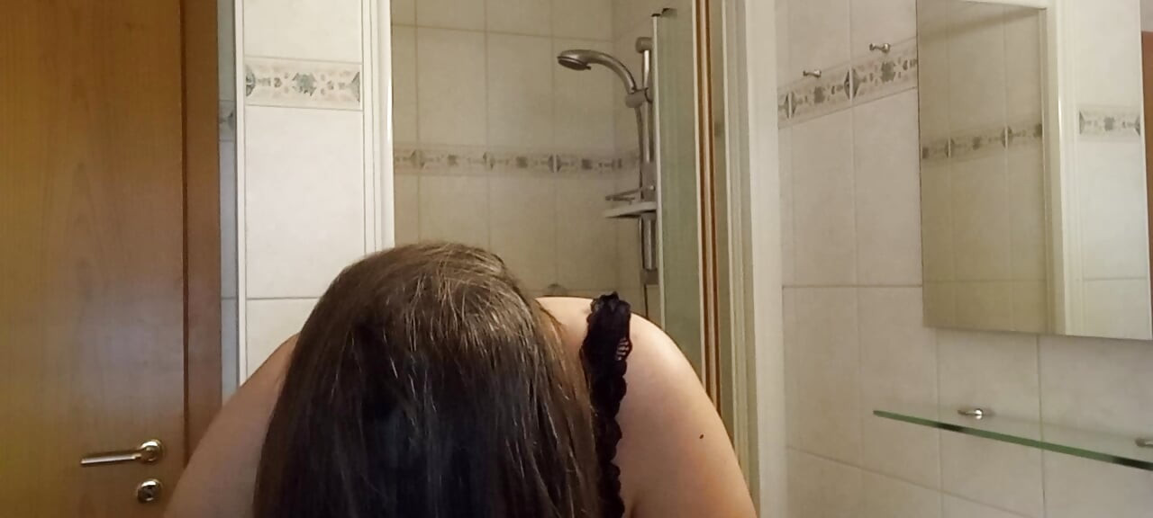 Mature woman with real silver strands slowly combs her long hair