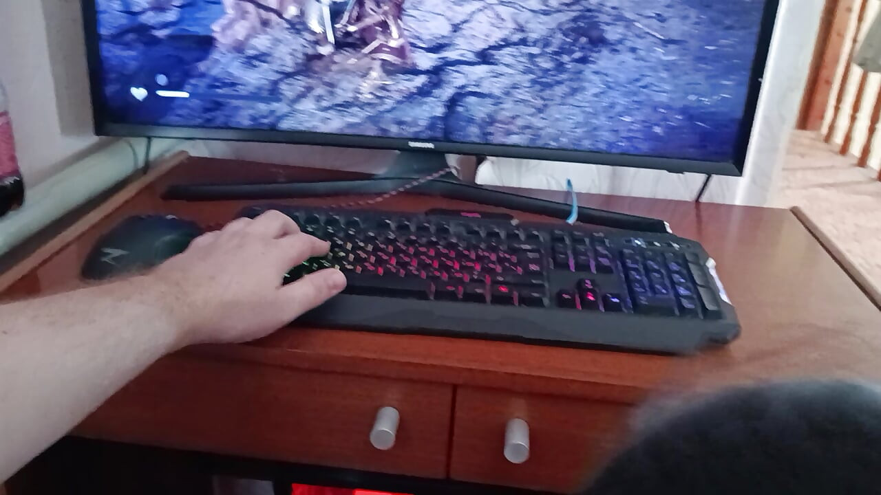 Korean woman sucks a nerd's cock while he's playing on the computer