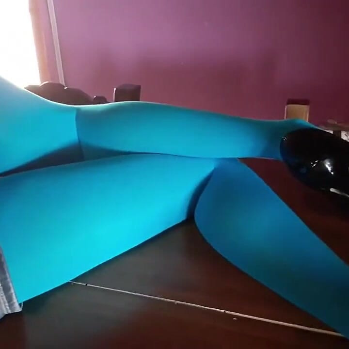 MILF with Beautiful Legs in Pantyhose and Heels Lying on the Table