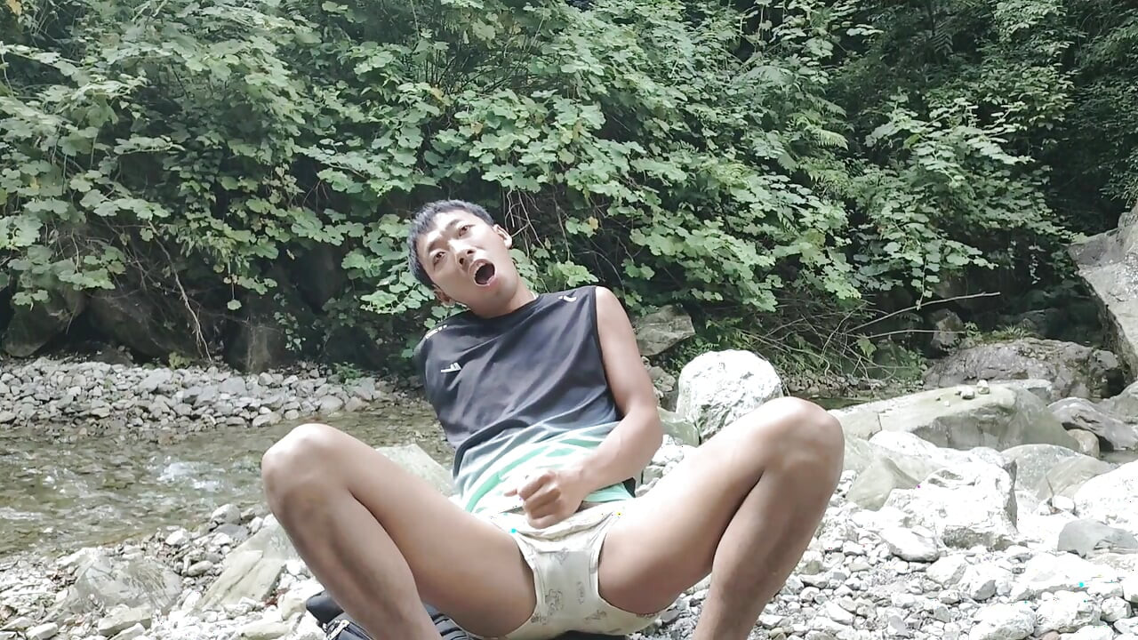A wild boy masturbates, moaning and ejaculating by a stream in the deep mountains, and then eats his own semen
