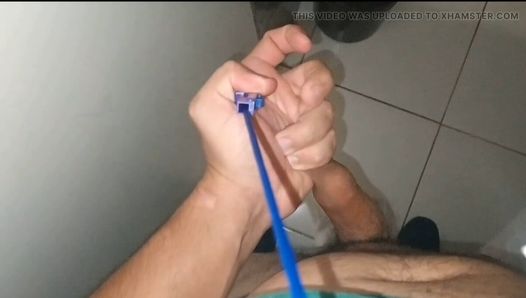 A pointed hose inserted inside the boy's cock.