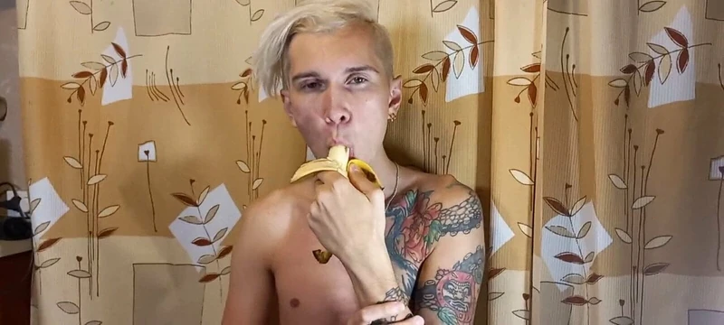 Sweet boy eats a banana greedily