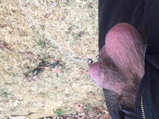 Pierced cock pissing outdoors