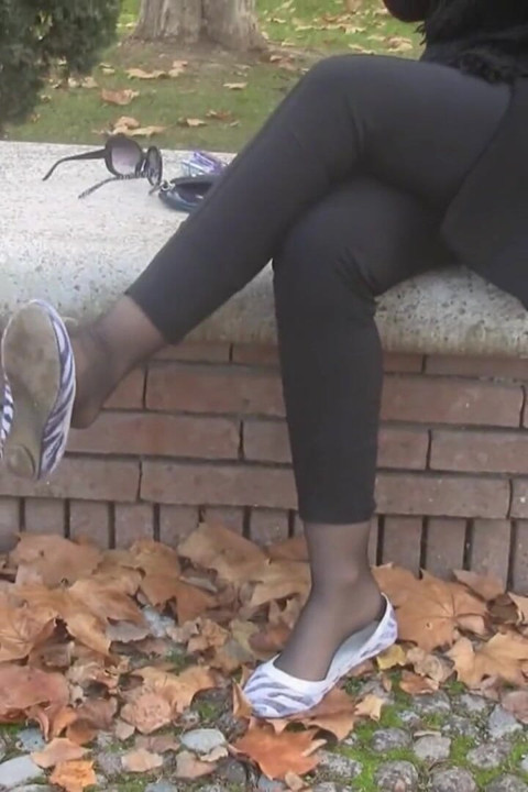 Beautiful blonde smoker showing her feet outdoors