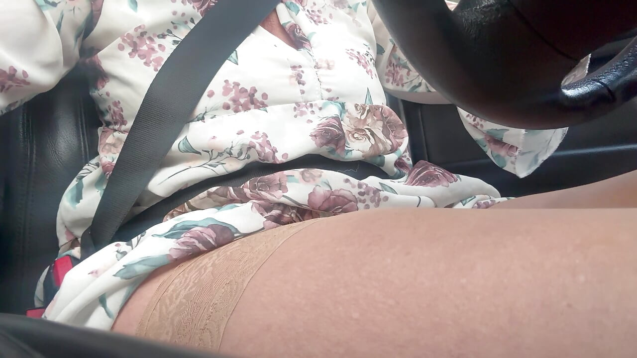 Bini matang panas yang elegan menunjukkan kaki seksinya dalam stoking semasa dia memandu ke pejabat