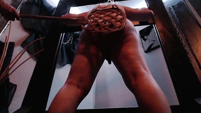Spanking with carpet beater and cane
