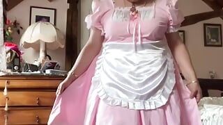In a pink and white maid's outfit