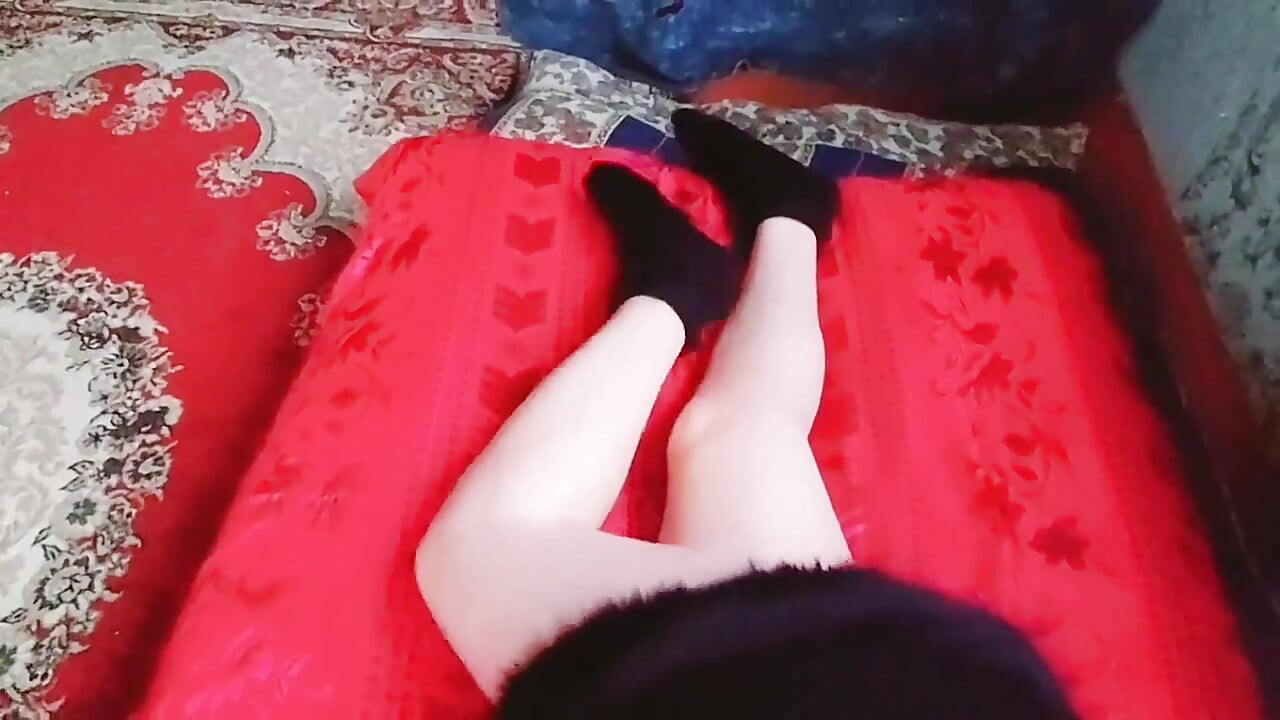 Cute sissy laying on sofa with soft pink blanket