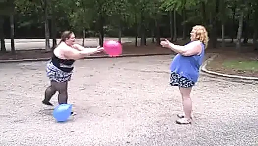 BBW gals play volley ball with balloons