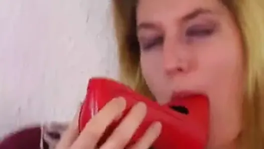 Blonde stuffing red shoe in her pussy