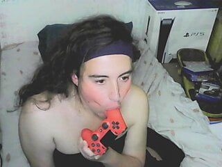 Cute cd girl, beautiful eyes and face. Kissing, licking and sucking a playstation controller. Sweet cd girl next door.