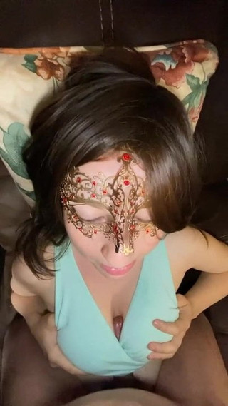 Masked brunette gives clothed titty fucking