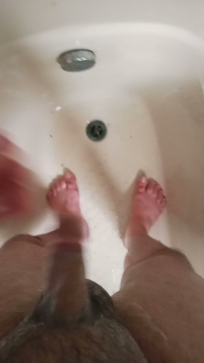 Sexy man with a large penis taking a shower