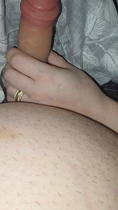 Step sister surprises step brother with a handjob while they watch a movie