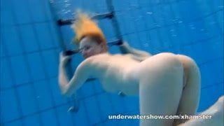 Cute Lucie is stripping underwater