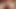 Mit verbundenen Augen wird ein Typ mit einem Strapon gefickt