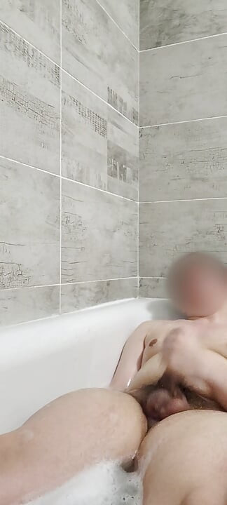 Teen boy playing in bathtub and showing feet
