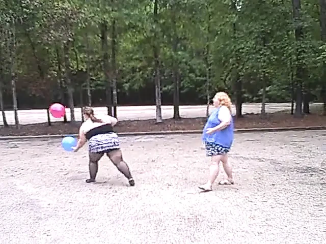 BBW gals play volley ball with balloons