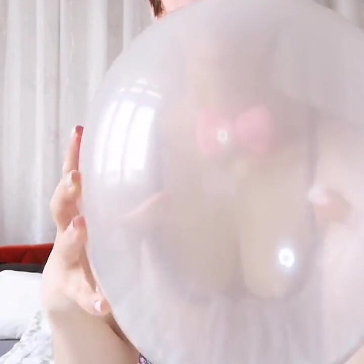 Easter bunny plays with balloons