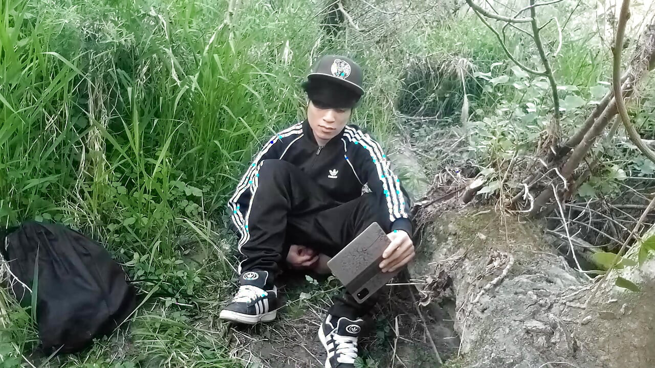 Cute Asian gay twink in a black-and-white adidas tracksuit and Campus sneakers masturbates and cums outdoors