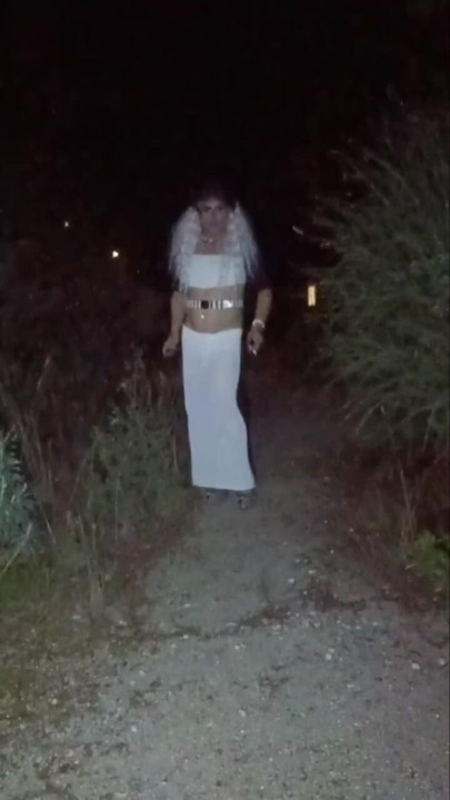 mature crossdresser in high heels smoke in the park
