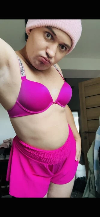 sissy in pink fucks her mouth with a dildo