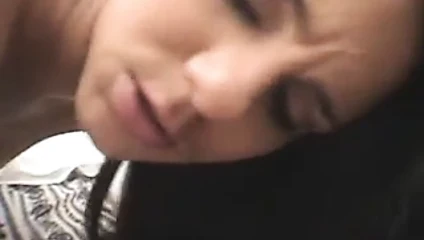 Slutty blonde with curly hair is masturbating her dick on the sofa